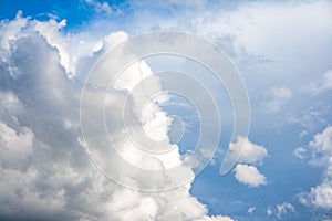 Large clouds making shapes on a blue background