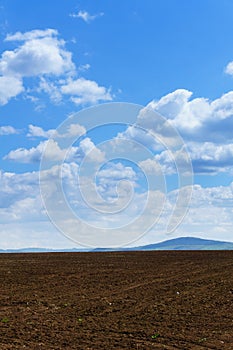 Large clouds over Cultivated field in countryside