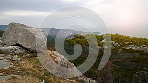 Large cobbles and lonely tree high on a mountain