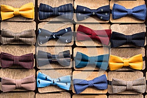 A large collection of Bow Ties of various colors. All items of clothing are on stands