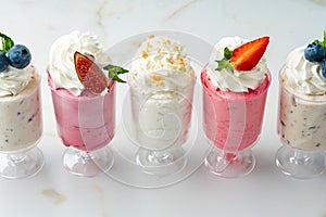 Large collection of mousse desserts in glasses for catering