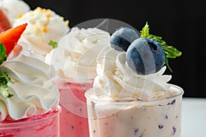 Large collection of mousse desserts in glasses for catering