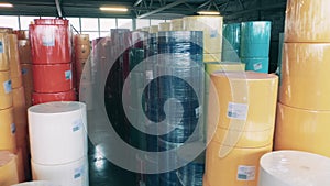 Large colorful paper rolls stored in a warehouse