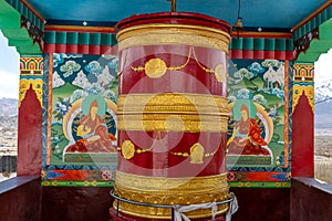 Large, colorful prayer wheel at a historic Buddhist monastery in India