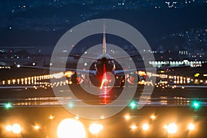 Large commercial airplane landing or take off on runway at night. Journey abroad tourism, oversea travel, flight transit