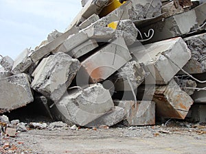 Large concrete chunks with twisted metal on a demolition site