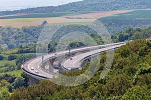 Large concrete overpass with some cars on it