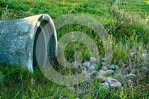 A large concrete pipe for diverting the river under the highway. Leaky dirty water from large concrete pipes. Dirty sewage from