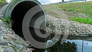 A large concrete pipe for diverting the river under the highway. Leaky dirty water from large concrete pipes. Dirty sewage from