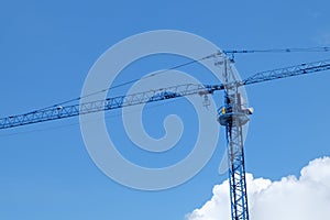 Large construction crane machine with clear blue sky