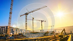 Large construction site including several cranes, with clear sky photo