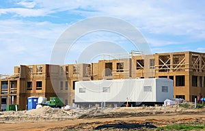 Large construction site with mobile job location office trailer on a sunny morning