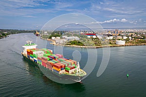Large container ship leaving port. Aerial view of cargo container ship vessel import export container sailing