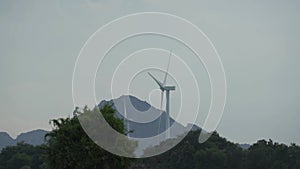 Large contemporary windmills with blades on wind farm