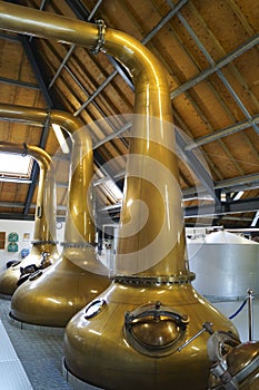 Large copper pot stills in a distillery