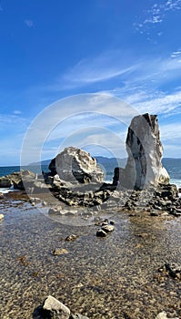 Large coral rocks adorn the view on the beach photo