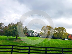 Large country house. Autumn landscape with a large trimmed lawn