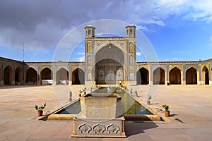 The large courtyard of Vakil Mosque with a beautiful pool in the middle, Shiraz, Iran.