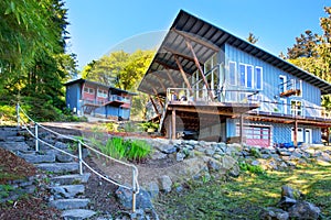 Large covered and furnished porch of luxury house with view of the lake