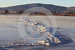 Winter Ice Cracked across a Frozen Lake