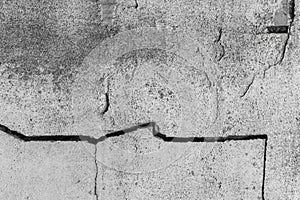 Large crack on the old broken concrete surface of the cement wall cracked texture damaged background