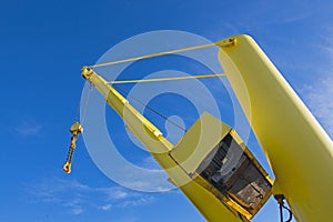 Large crane jib against blue sky background