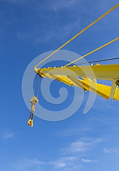 Large crane jib against blue sky background