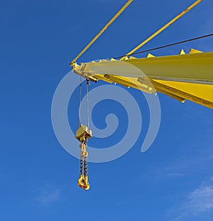 Large crane jib against blue sky background