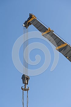 Large crane jib against blue sky background