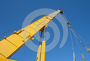 Large crane jib against blue sky background