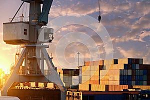 Large crane for unloading or loading in the port. A open-air warehouse for shipping containers in a seaport