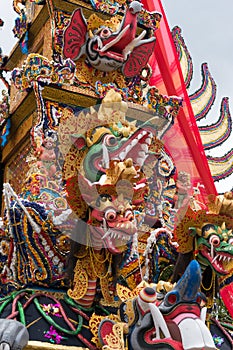 A large cremation tower `Bade` is carried through the streets of Ubud, Bali