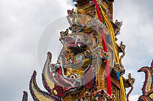A large cremation tower `Bade` is carried through the streets of Ubud, Bali