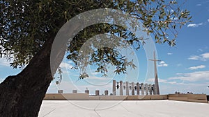 Large cross and bells through olive tree in Puglia - South Italy