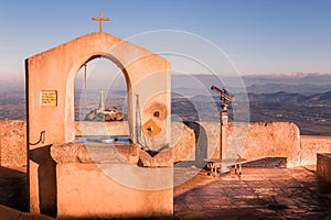 Large cross framed by a well at sunrise,l Sant Salvador, Felanitx, Mallorca, Spain