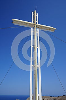 A large cross stands on a hill near the Church of Prophet Elias. Pefkos or Pefki, Rhodes island, Greece