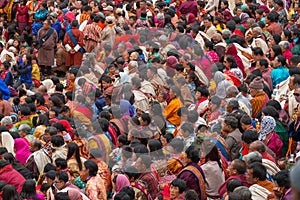 Crowd watch dancers at Tshechu religious festival in Paro fortress, Bhutan