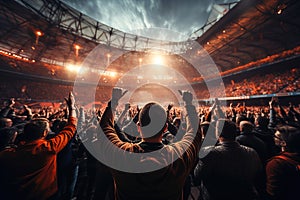 A large crowd of people at a soccer stadium. Football game. Many hands up