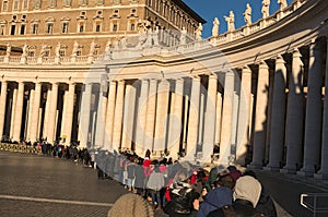 A large crowd of tourists and pilgrims, unidentified, waits in line to enter the Vatican Museums from early morning. Vatican. Rome