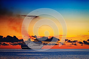 Large cruise ship on calm sea at sunset