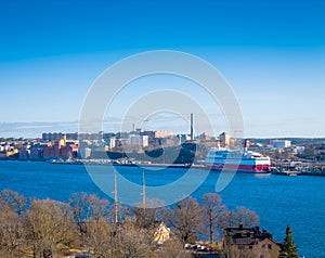 A large cruise ship docked at the shore of Stockholm, Sweden. Aerial photo