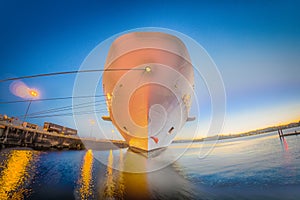 Large cruise ship moored at pier at sunset