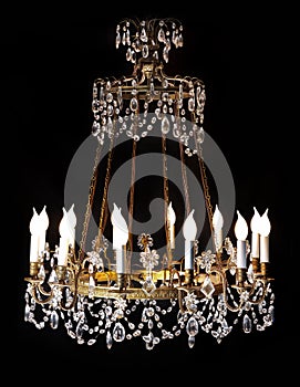 Large crystal chandelier isolated on black background.