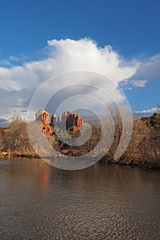 Large cumulus cloud over Cathedral Rock in Red Rock State Park outside of Sedona, Arizona in winter.