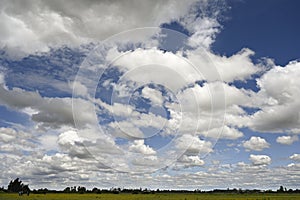 Large cumulus clouds cover a large area of the sky.