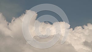 Large cumulus clouds swirl rapidly in the sky. beautiful sky above the ocean with pink clouds. Epic stormy tropical