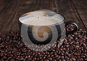 Large cup with hot cappuchino with coffee beans