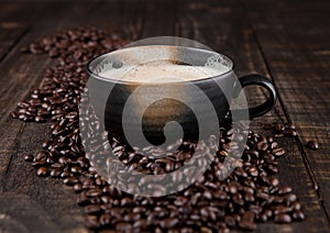 Large cup with hot cappuchino with coffee beans