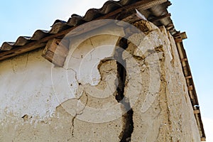 A large dangerous crack in the wall of the house. Destroying the house