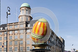 A large decorative Easter egg against a building in the city of Copenhagen